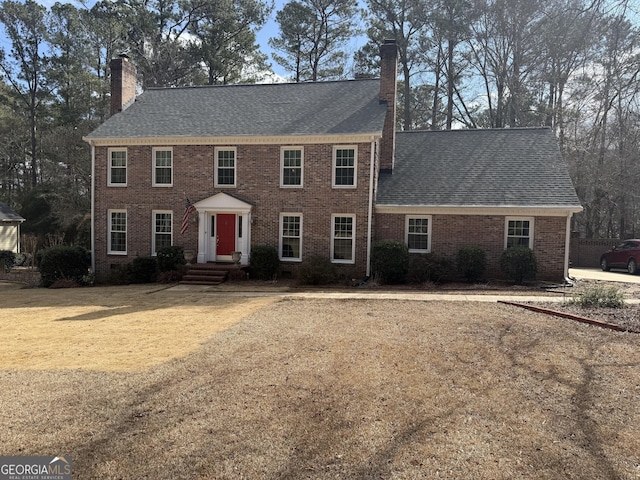 colonial inspired home with a front yard