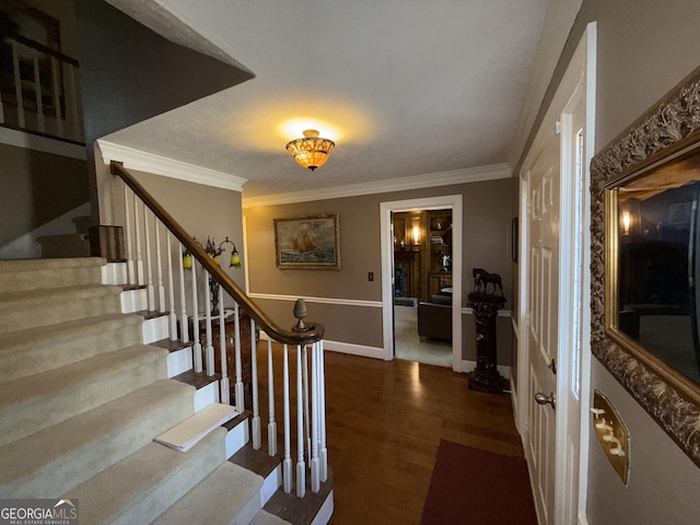 entryway with crown molding and dark hardwood / wood-style flooring