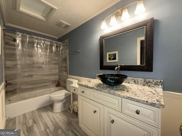 full bathroom with tiled shower / bath, hardwood / wood-style flooring, vanity, toilet, and crown molding