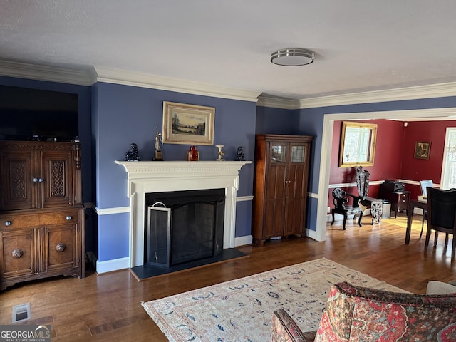 living room featuring dark wood-type flooring and ornamental molding