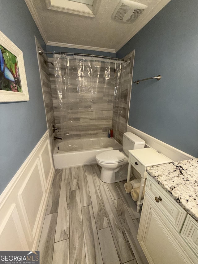 full bathroom featuring tiled shower / bath combo, ornamental molding, hardwood / wood-style floors, and toilet