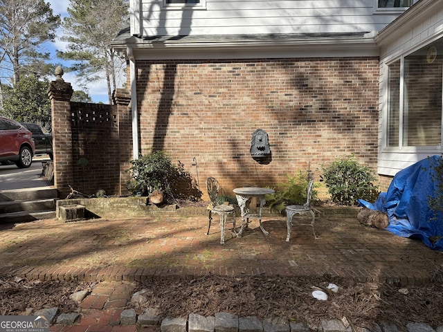 view of side of property with a patio