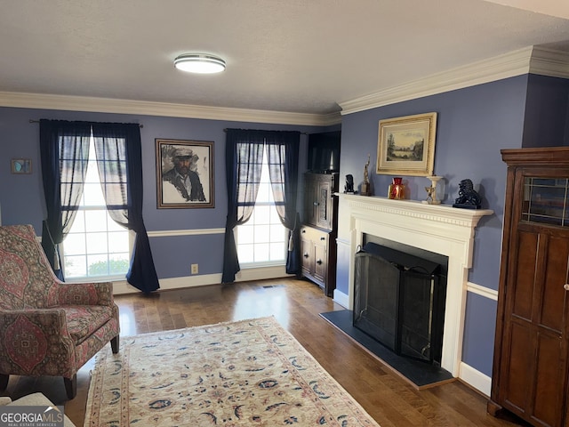 living room featuring dark wood-type flooring and ornamental molding