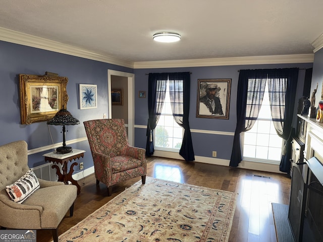 sitting room with crown molding and dark wood-type flooring