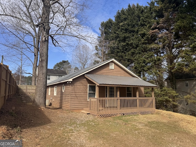 back of property featuring a yard, fence, and a wooden deck