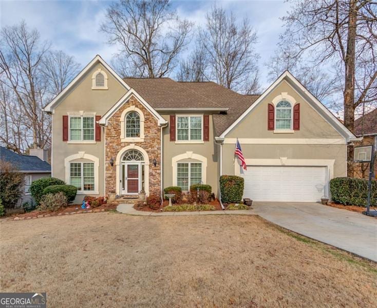 front of property featuring a garage and a front lawn