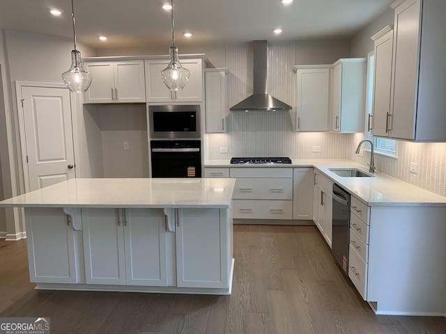 7406 Grand Reunion Dr, Hoschton, GA 30548 - kitchen with wall chimney exhaust hood, appliances with stainless steel finishes, dark wood-style flooring, a sink, and a kitchen island