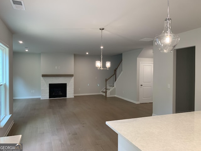 7406 Grand Reunion Dr, Hoschton, GA 30548 - unfurnished living room with dark wood-style floors, stairway, baseboards, a fireplace, and recessed lighting