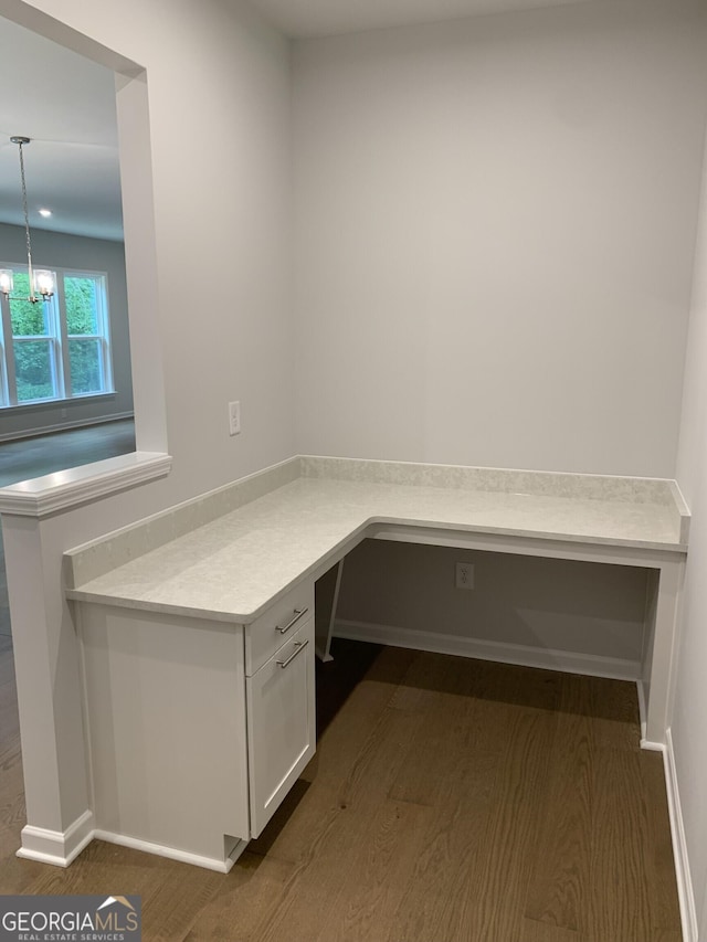 7406 Grand Reunion Dr, Hoschton, GA 30548 - unfurnished office featuring dark wood finished floors, a chandelier, and baseboards