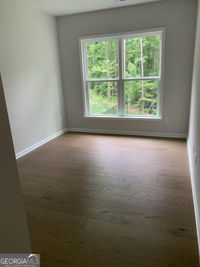 7406 Grand Reunion Dr, Hoschton, GA 30548 - spare room with baseboards and wood finished floors