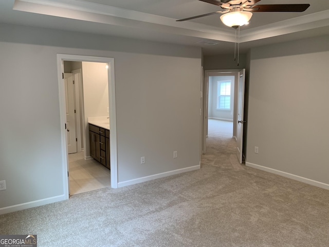 7406 Grand Reunion Dr, Hoschton, GA 30548 - unfurnished room with a tray ceiling, light carpet, ceiling fan, baseboards, and crown molding