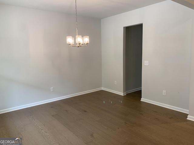 7406 Grand Reunion Dr, Hoschton, GA 30548 - empty room featuring a chandelier, dark wood finished floors, and baseboards