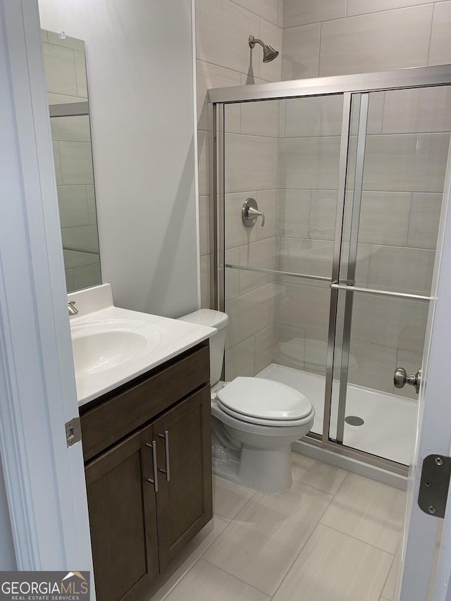 7406 Grand Reunion Dr, Hoschton, GA 30548 - bathroom with a stall shower, vanity, toilet, and tile patterned flooring