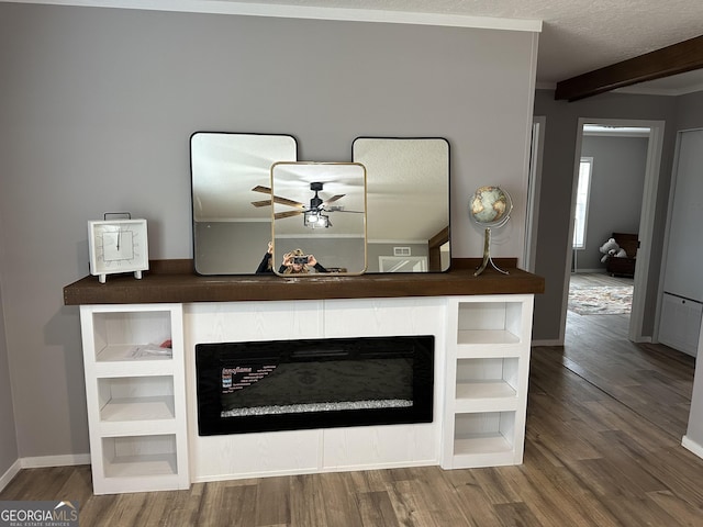 room details with hardwood / wood-style flooring, ceiling fan, a textured ceiling, and beamed ceiling