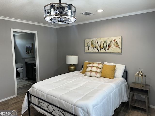 bedroom featuring dark hardwood / wood-style flooring, connected bathroom, and ornamental molding