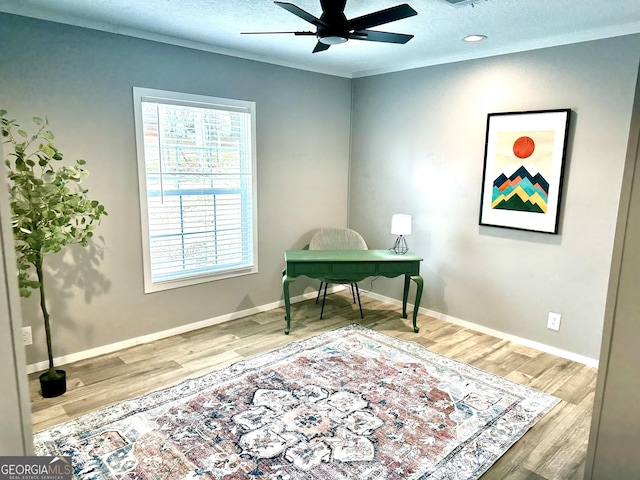 office area with crown molding, hardwood / wood-style flooring, a textured ceiling, and ceiling fan