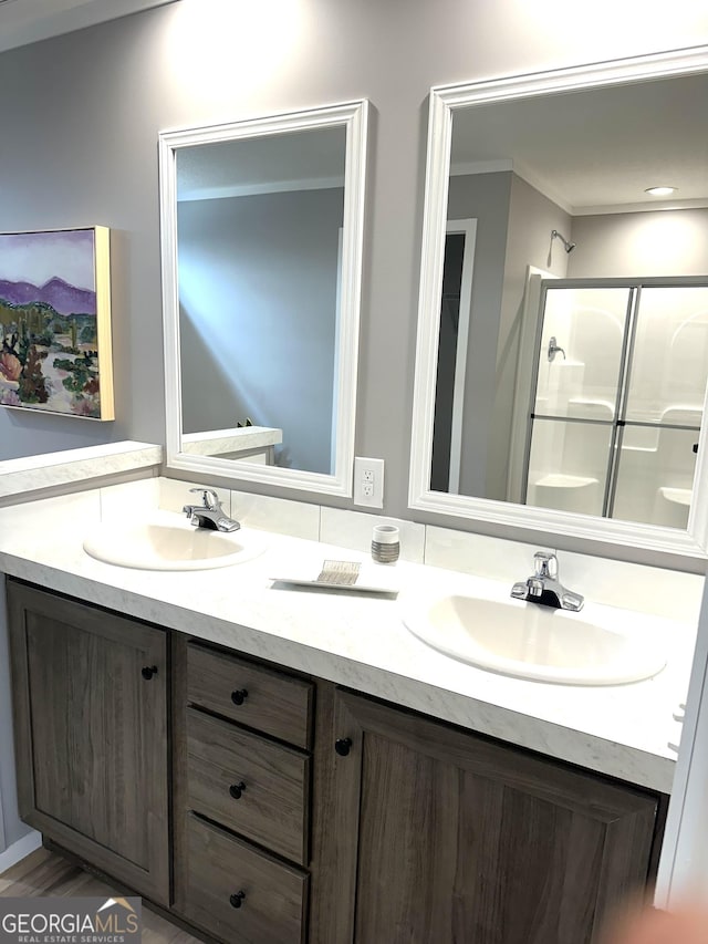 bathroom with vanity, crown molding, and walk in shower