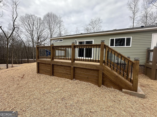 back of house with a wooden deck