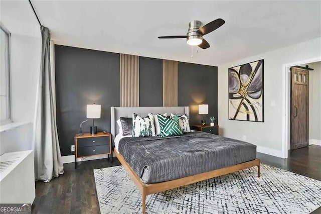 bedroom with dark hardwood / wood-style floors and ceiling fan