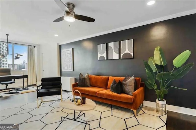 living room with crown molding and ceiling fan