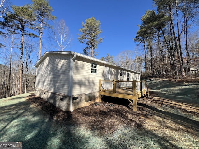 view of side of home featuring a wooden deck