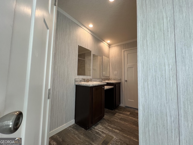 bathroom featuring vanity, wood-type flooring, and ornamental molding