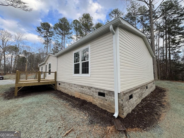 view of home's exterior featuring a wooden deck