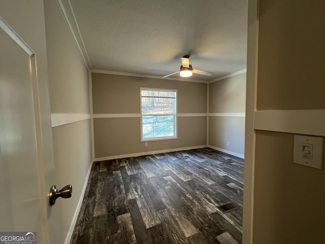 unfurnished room with ornamental molding, dark hardwood / wood-style floors, and ceiling fan