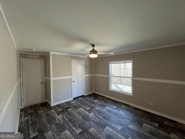 unfurnished bedroom featuring ornamental molding, ceiling fan, a textured ceiling, and dark hardwood / wood-style flooring