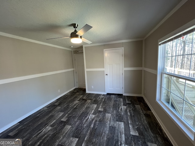 unfurnished bedroom featuring crown molding, dark wood-type flooring, ceiling fan, and a textured ceiling