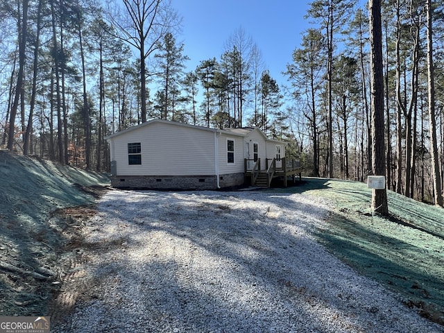 view of side of home featuring a wooden deck