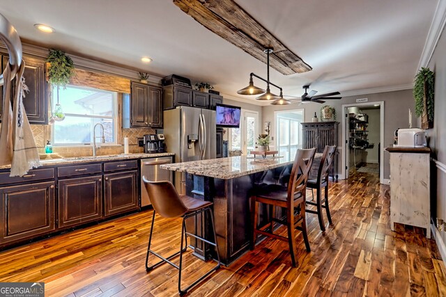 520 Long View Dr, Hiawassee, GA 30546 - kitchen with appliances with stainless steel finishes, a breakfast bar area, wood-type flooring, dark brown cabinets, and crown molding