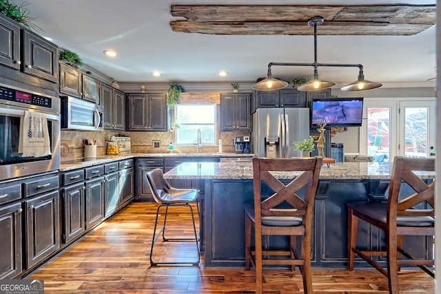 520 Long View Dr, Hiawassee, GA 30546 - kitchen with stainless steel appliances, a kitchen breakfast bar, light wood finished floors, a sink, and recessed lighting