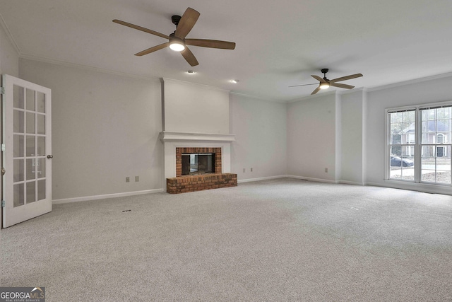 unfurnished living room featuring a fireplace, ornamental molding, and carpet flooring