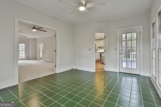 tiled empty room with crown molding and ceiling fan