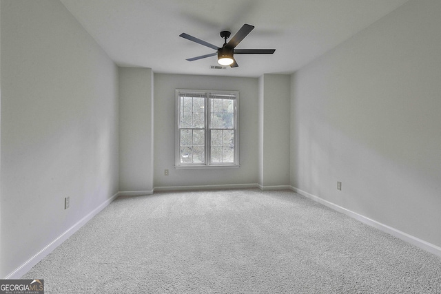 carpeted empty room featuring ceiling fan