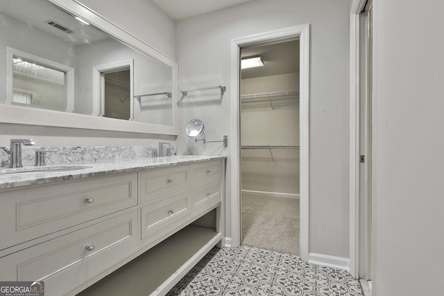 bathroom with tile patterned floors and vanity