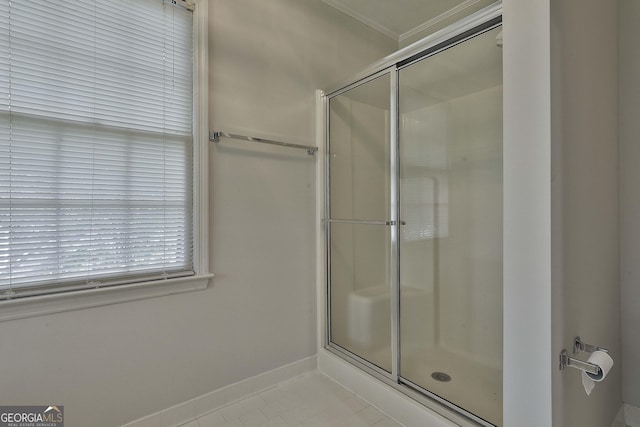 bathroom featuring tile patterned floors and a shower with shower door