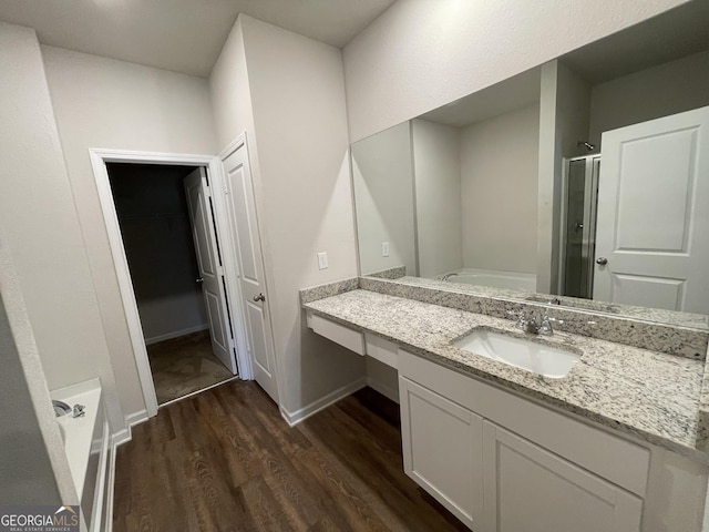 bathroom featuring wood-type flooring, separate shower and tub, and vanity