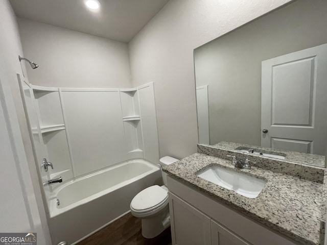 full bathroom featuring washtub / shower combination, vanity, toilet, and hardwood / wood-style floors