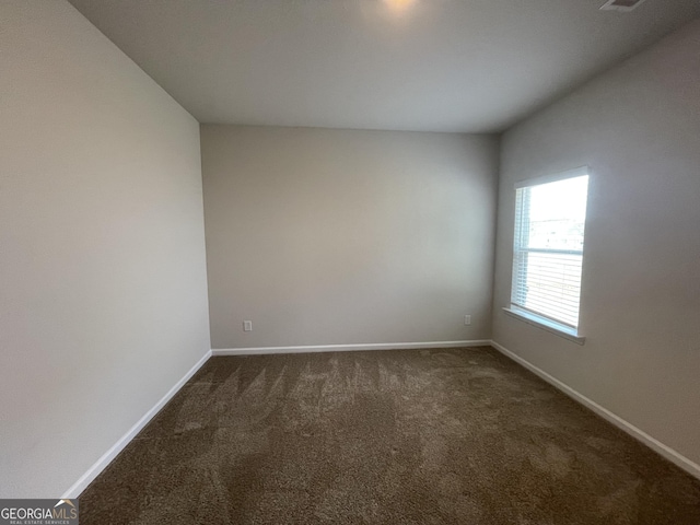 empty room with dark carpet