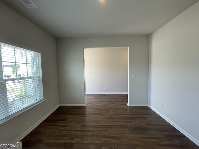 unfurnished room featuring dark hardwood / wood-style flooring