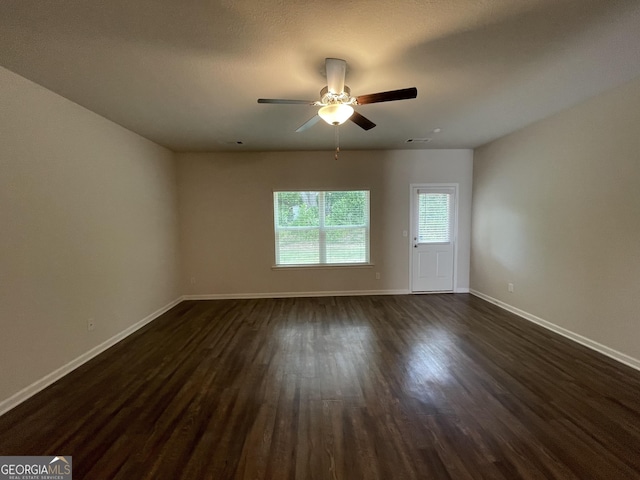 unfurnished room with dark hardwood / wood-style floors and ceiling fan