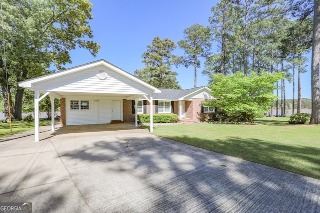 view of front of property with a front yard and a carport