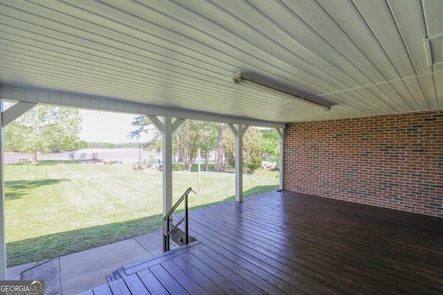 wooden deck featuring a yard