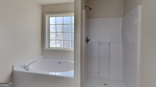 bathroom featuring independent shower and bath