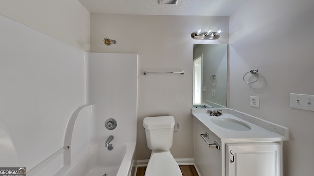 full bathroom featuring shower / bath combination, vanity, a textured ceiling, and toilet