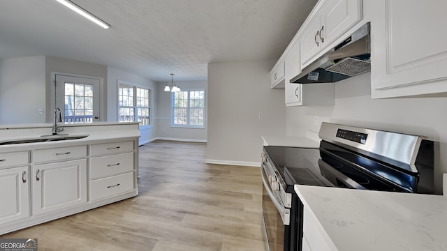 kitchen featuring sink, white cabinetry, light hardwood / wood-style floors, stainless steel electric range oven, and decorative light fixtures