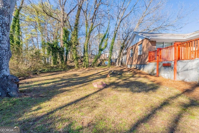 view of yard featuring a wooden deck