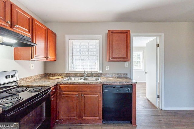 kitchen with sink, hardwood / wood-style floors, and black appliances